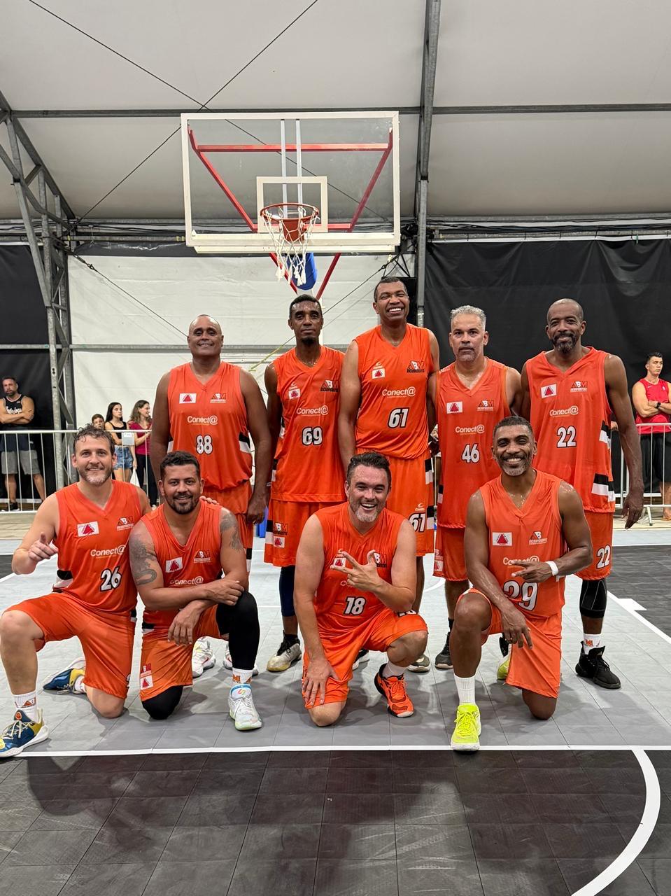 Equipe da ABM Inconfidentes com uniforme laranja em quadra coberta